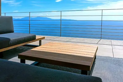 a living room with a couch and a coffee table at Villa petra mare in Cargèse