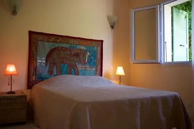 a bedroom with a bed with a painting of an elephant at A Casa Ghjalla in Cauro