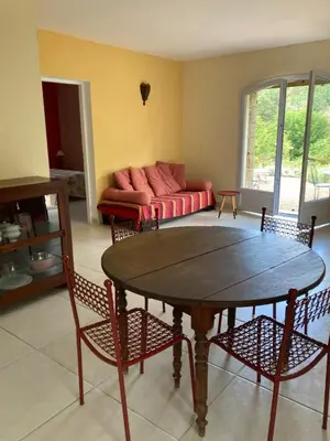 a living room with a table and a couch at A Casa Ghjalla in Cauro