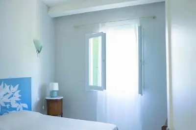 a bedroom with a bed and a window at A Casa Ghjalla in Cauro