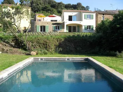 a swimming pool in front of a house at A Casa Ghjalla in Cauro
