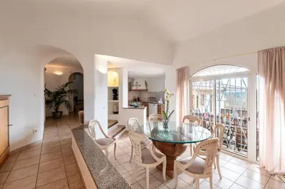 a dining room with a glass table and chairs at Villa de standing piscine- vue mer panoramique in Porto-Vecchio