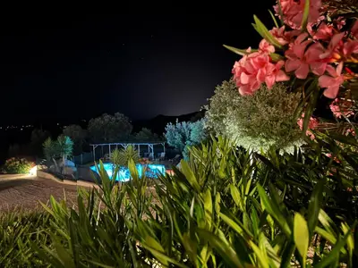 a view of a swimming pool at night at Villa Tonnara - Maison du soleil in Sotta