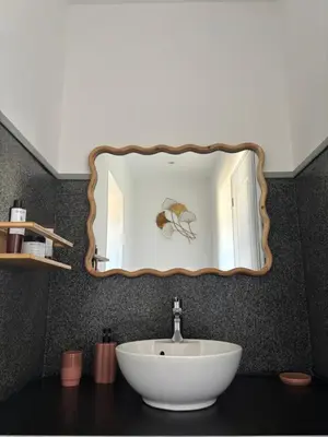 a bathroom with a white sink and a mirror at Villa Tonnara - Maison du soleil in Sotta