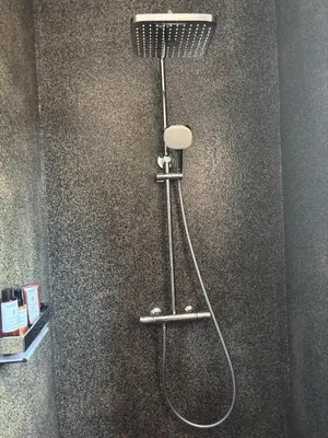 a shower with a shower head in a bathroom at Villa Tonnara - Maison du soleil in Sotta
