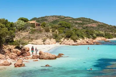 a view of a beach with a boat in the water at Chalet 3 étoiles - Parc aquatique - ccbcbfb in Sartène
