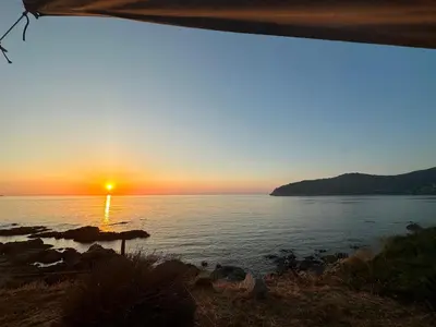 a sunset over a body of water at T3 neuf avec terrasse panoramique de 35m2 - Vue mer exceptionnelle in Villanova