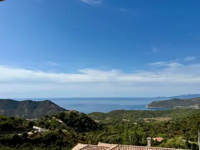 a view of the ocean from a hill at T3 neuf avec terrasse panoramique de 35m2 - Vue mer exceptionnelle in Villanova