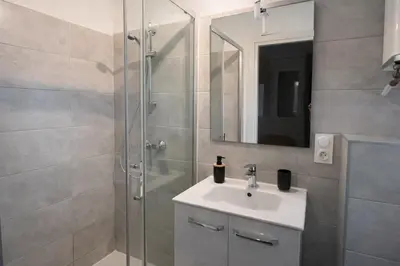 a bathroom with a sink and a shower at Résidence Luna, Saint-Cyprien in Porto-Vecchio