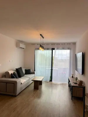 a living room with a couch and a table at Appartement T2 calme et paisible Vescovato in Venzolasca