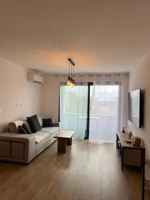 a living room with a couch and a table at Appartement T2 calme et paisible Vescovato in Venzolasca