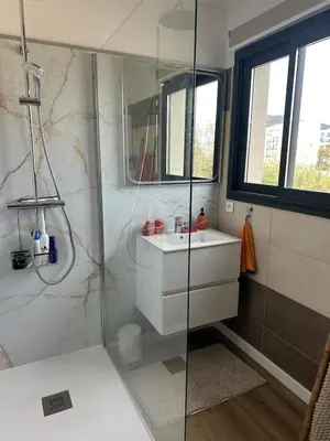 a bathroom with a glass shower and a sink at Appartement T2 calme et paisible Vescovato in Venzolasca