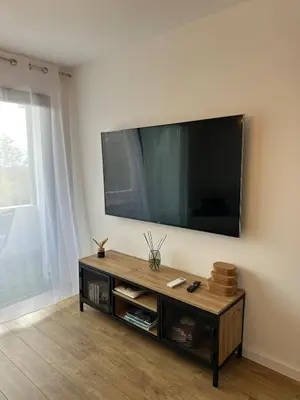 a living room with a flat screen tv on the wall at Appartement T2 calme et paisible Vescovato in Venzolasca