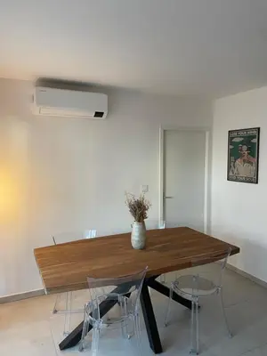 a dining room with a wooden table and chairs at charmant appartement a ajaccio in Ajaccio