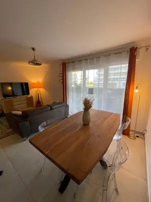 a living room with a wooden table and a couch at charmant appartement a ajaccio in Ajaccio