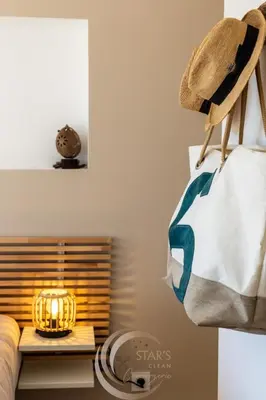 a room with a bed with a bag and a lamp at Villa Neuve Corse sud avec vue mer et piscine chauffée in Pianottoli-Caldarello