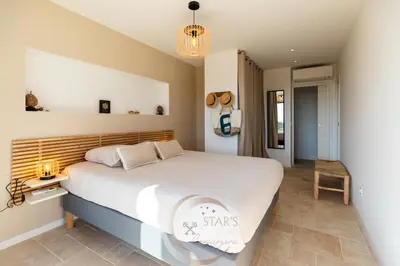 a bedroom with a large bed in a room at Villa Neuve Corse sud avec vue mer et piscine chauffée in Pianottoli-Caldarello