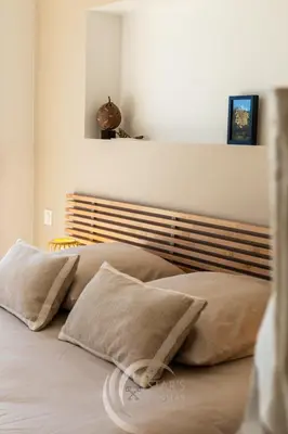 a bed with two pillows on it in a bedroom at Villa Neuve Corse sud avec vue mer et piscine chauffée in Pianottoli-Caldarello