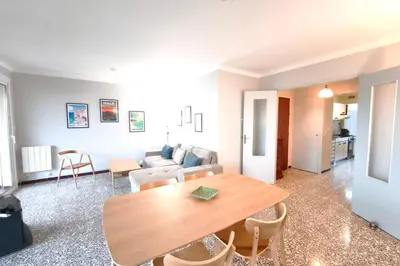 a living room with a table and a couch at Bright apartment with balcony in Ajaccio in Ajaccio