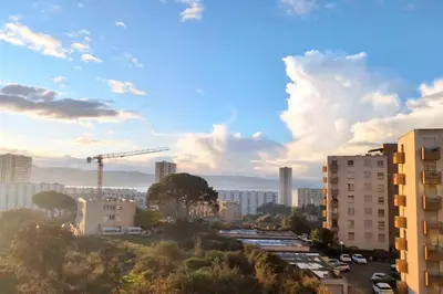 a view of a city with buildings and a crane at Bright apartment with balcony in Ajaccio in Ajaccio