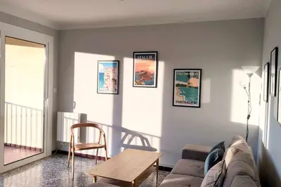 a living room with a couch and a table at Bright apartment with balcony in Ajaccio in Ajaccio