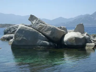a group of rocks in the water at Holiday apartment with 1 bedroom in Montegrosso