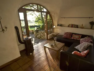 a pergola with ivy on it next to a field at Holiday apartment with 1 bedroom in Montegrosso