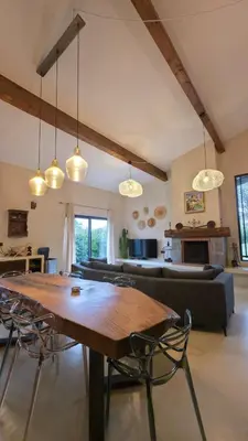 a living room with a table and chairs and a couch at Villa Aria Natura, calme sérénité piscine chauffée in Porto-Vecchio