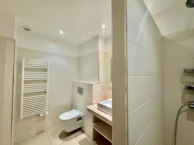 a white bathroom with a toilet and a sink at T2 au cœur de Propriano in Propriano
