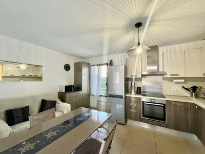 a kitchen with a couch and a table in a room at T2 au cœur de Propriano in Propriano