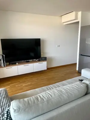 a living room with a large flat screen tv at T2 avec vue panoramique in Ajaccio
