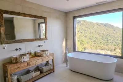 a bathroom with a tub and a large window at Villa Aberia Di Santa Lucia in Sainte-Lucie de Porto-Vecchio