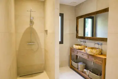 a bathroom with two sinks and a mirror at Villa Aberia Di Santa Lucia in Sainte-Lucie de Porto-Vecchio