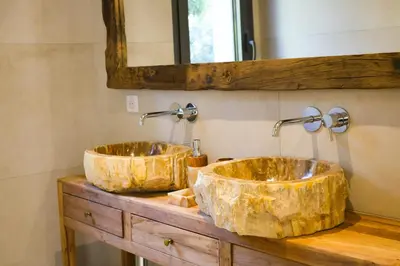 two sinks on a wooden counter in a bathroom at Villa Aberia Di Santa Lucia in Sainte-Lucie de Porto-Vecchio