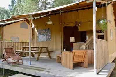 a tent with a table and chairs on a deck at Camping 3 étoiles - Piscine - ccbccbe in Sartène