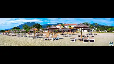 a bunch of chairs and umbrellas on a beach at Bungalow 4 people - Marea Resort in Santa-Lucia-di-Moriani