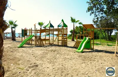 a playground on the beach with a slide at Bungalow 4 people - Marea Resort in Santa-Lucia-di-Moriani