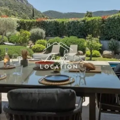 a table with wine glasses on top of it at Villa route de Palombaggia in Porto-Vecchio