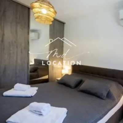 a bedroom with a bed with two towels on it at Villa route de Palombaggia in Porto-Vecchio