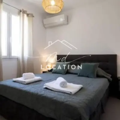 a bedroom with a bed with two towels on it at Villa route de Palombaggia in Porto-Vecchio