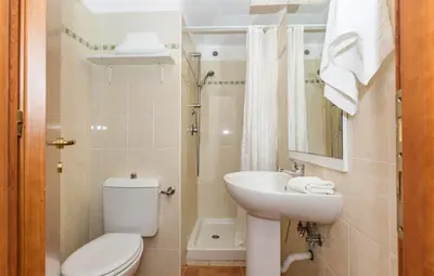 a white bathroom with a toilet and a sink at Apartment T2 - 200 m from the sea in Linguizzetta