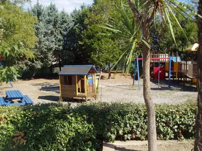 a small playground with a small house in a park at Apartment T2 - 200 m from the sea in Linguizzetta