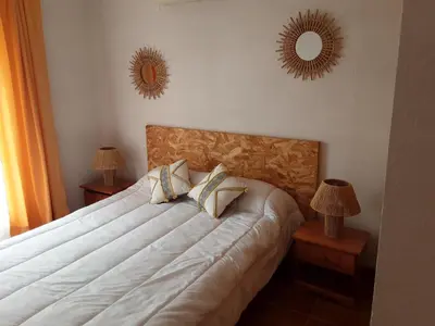 a bedroom with a bed with two mirrors on the wall at La Palombière - La Bruyère in Casalabriva