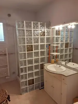 a bathroom with a sink and a glass wall at La Palombière - La Bruyère in Casalabriva