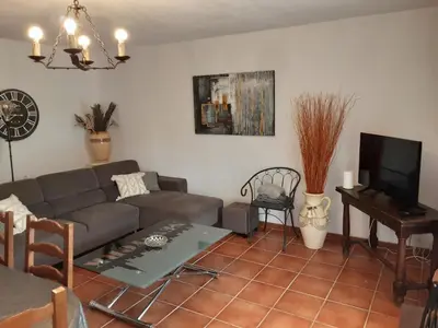 a living room with a couch and a table at La Palombière - La Bruyère in Casalabriva