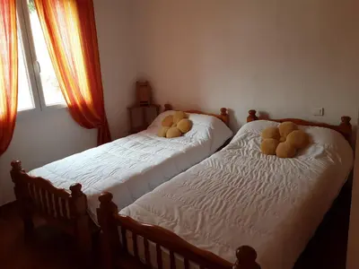 two beds with teddy bears on them in a bedroom at La Palombière - La Bruyère in Casalabriva