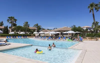 a group of people in a swimming pool at a resort at T2 - next to the sea in Linguizzetta