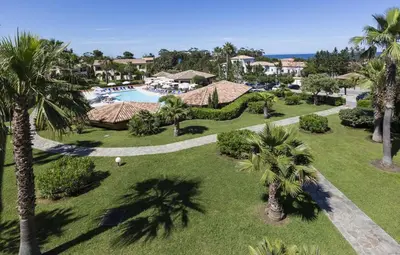 an aerial view of a resort with a pool and palm trees at T2 - next to the sea in Linguizzetta
