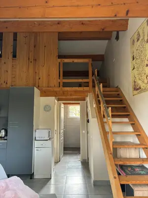 a kitchen with a staircase in a house at Cozy mini villa proche plages, calme & activés in Bonifacio