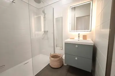 a bathroom with a shower and a sink and a mirror at Bright studio with sea view in Ajaccio in Ajaccio